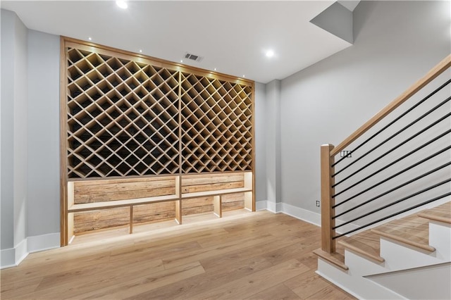 wine area with light hardwood / wood-style floors