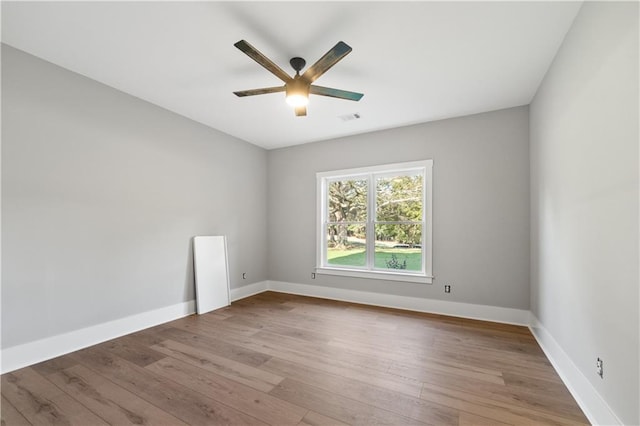 spare room featuring ceiling fan and light hardwood / wood-style flooring