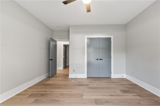 unfurnished bedroom with a closet, ceiling fan, and light hardwood / wood-style floors