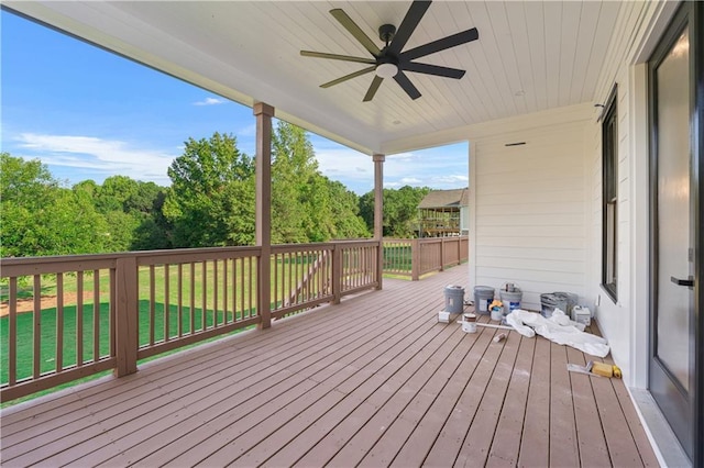 wooden deck featuring ceiling fan and a lawn