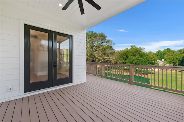 deck featuring ceiling fan and a yard