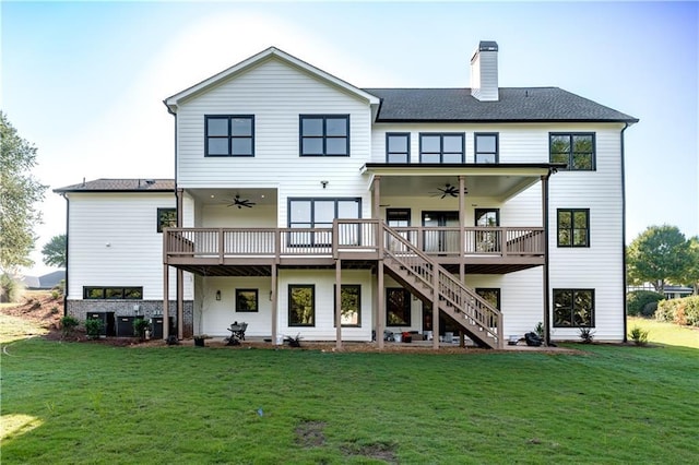 back of house with a wooden deck, ceiling fan, and a yard