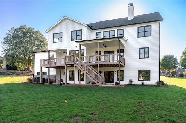 back of house with a lawn, ceiling fan, and a wooden deck