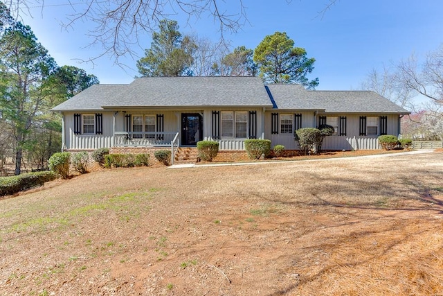 ranch-style house with board and batten siding and a porch