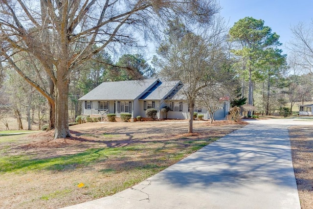 single story home with covered porch and driveway