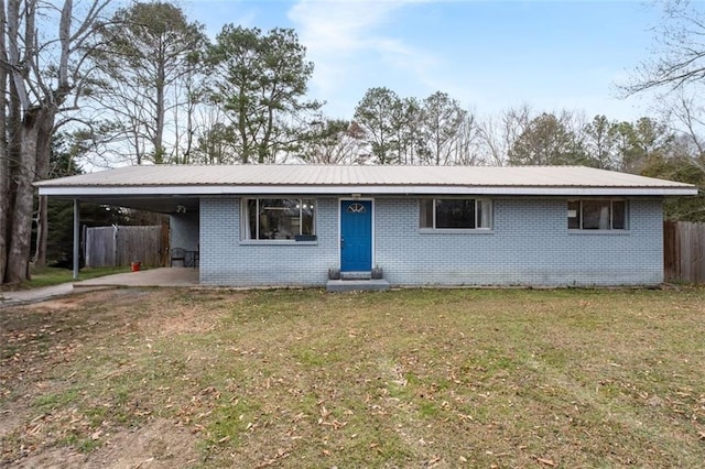 single story home with metal roof, an attached carport, fence, and brick siding