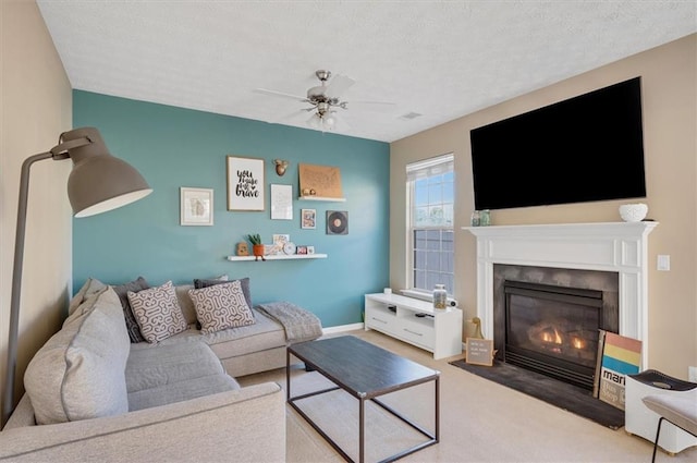 living room featuring a textured ceiling, ceiling fan, and carpet flooring