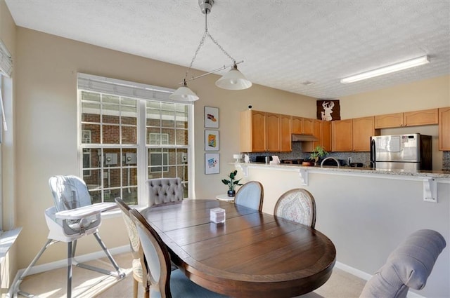 dining space featuring a textured ceiling