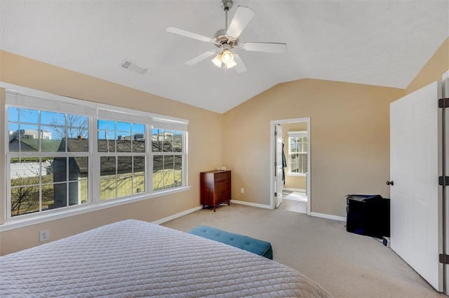 carpeted bedroom with vaulted ceiling, ceiling fan, and multiple windows