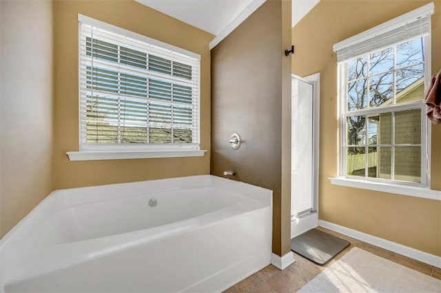 bathroom with tile patterned flooring and shower with separate bathtub