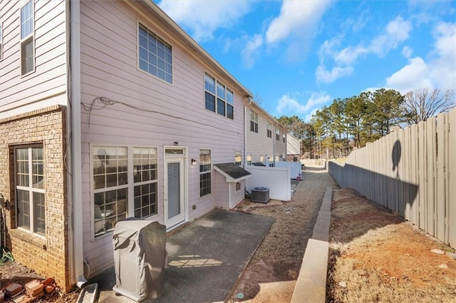 view of property exterior featuring central air condition unit and a patio