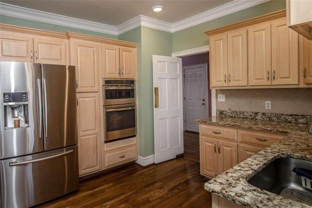 kitchen with light stone counters, dark hardwood / wood-style floors, light brown cabinets, and appliances with stainless steel finishes