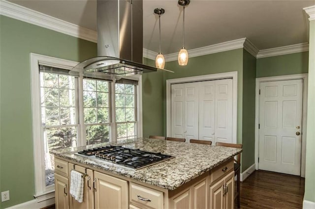 kitchen with crown molding, dark wood finished floors, island exhaust hood, stainless steel gas stovetop, and light stone countertops