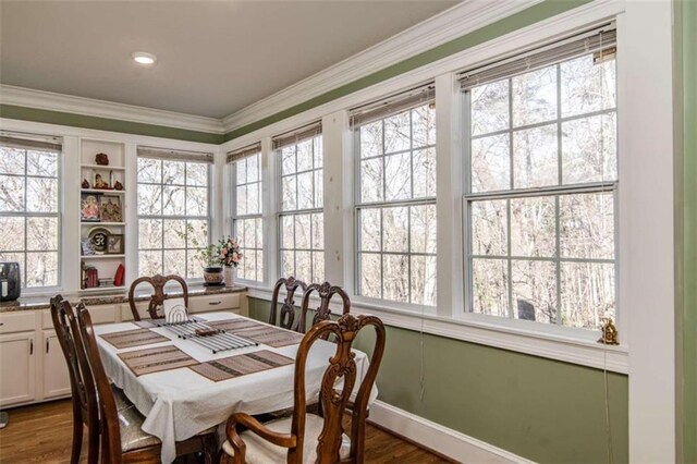 dining area featuring crown molding, a healthy amount of sunlight, and hardwood / wood-style floors