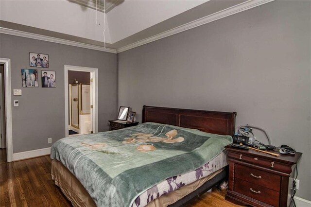 bedroom featuring ensuite bath, crown molding, and dark hardwood / wood-style flooring