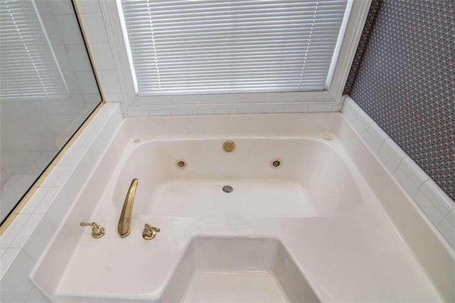 bathroom featuring a tub with jets