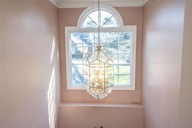 details featuring a chandelier and ornamental molding