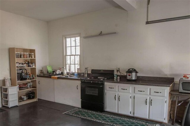 kitchen with white cabinetry and black range with gas cooktop