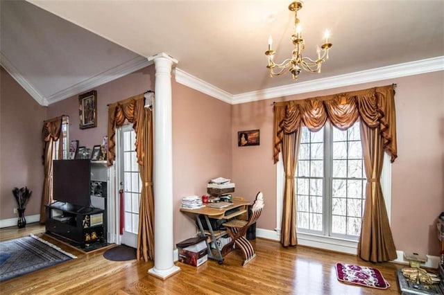 doorway to outside featuring crown molding, a chandelier, hardwood / wood-style flooring, and ornate columns