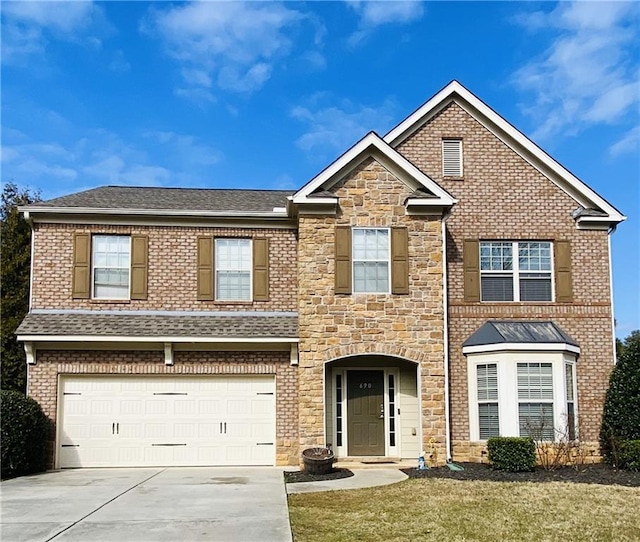 view of front facade featuring a front yard and a garage