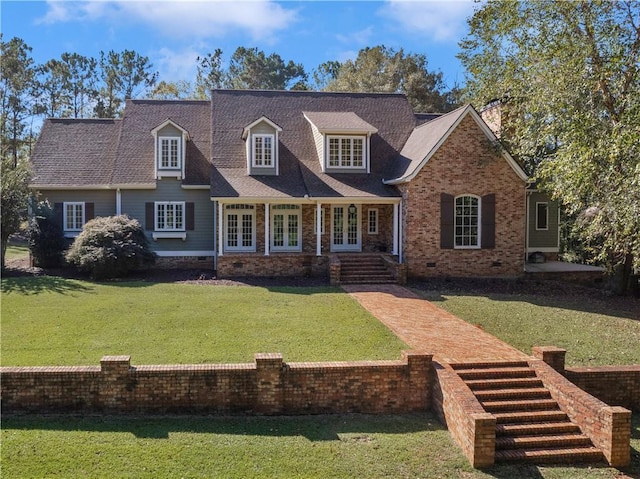 new england style home with french doors and a front lawn