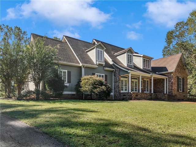 cape cod home with a front yard and a porch