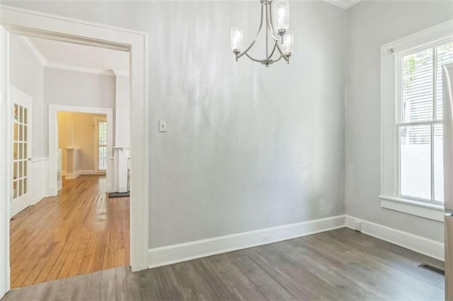 127 Rogers Ave, Macon, GA 31204 - unfurnished dining area featuring ornamental molding, wood finished floors, a chandelier, healthy amount of natural light, and baseboards