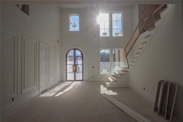 entryway with a towering ceiling and a wealth of natural light