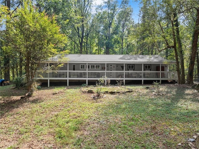 view of front facade featuring a deck and a front yard