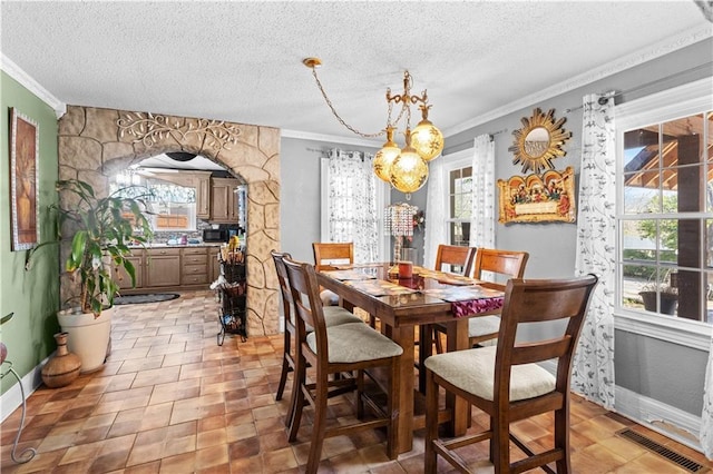 942 Hardwick Cir, Dalton, GA 30720 - dining area with ornamental molding, a wealth of natural light, visible vents, and arched walkways