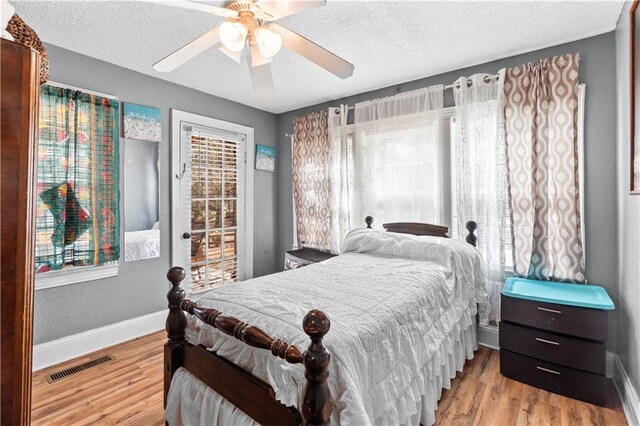 942 Hardwick Cir, Dalton, GA 30720 - bedroom featuring a textured ceiling, wood finished floors, visible vents, and baseboards