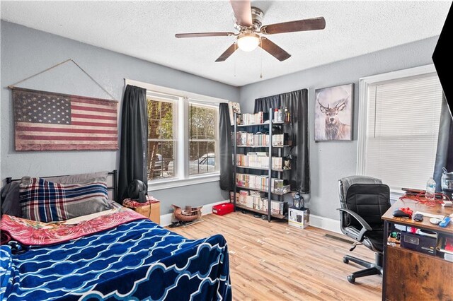 942 Hardwick Cir, Dalton, GA 30720 - bedroom with a ceiling fan, a textured ceiling, baseboards, and wood finished floors