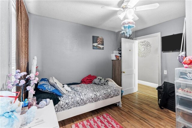 942 Hardwick Cir, Dalton, GA 30720 - bedroom featuring ceiling fan, a textured ceiling, baseboards, and wood finished floors