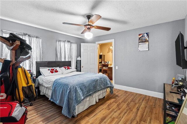 942 Hardwick Cir, Dalton, GA 30720 - bedroom with ceiling fan, a textured ceiling, baseboards, and wood finished floors