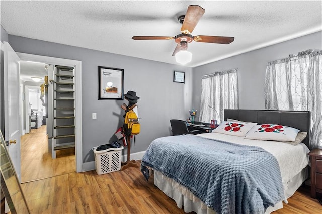 942 Hardwick Cir, Dalton, GA 30720 - bedroom featuring a textured ceiling, wood finished floors, a ceiling fan, and baseboards