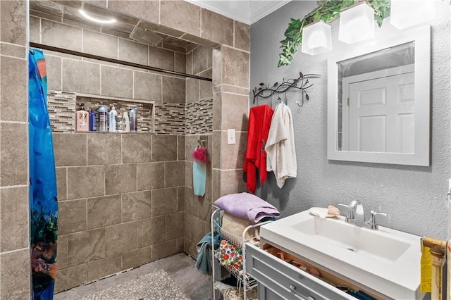 942 Hardwick Cir, Dalton, GA 30720 - bathroom with a textured wall, crown molding, a tile shower, and vanity
