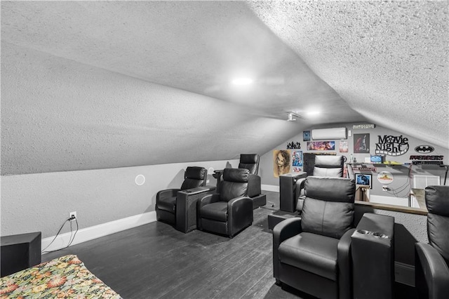 942 Hardwick Cir, Dalton, GA 30720 - home theater with lofted ceiling, a textured ceiling, a wall unit AC, wood finished floors, and baseboards