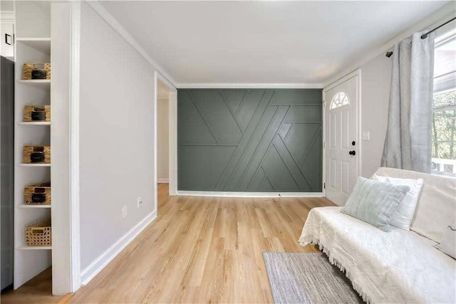 sitting room featuring light wood-type flooring and baseboards