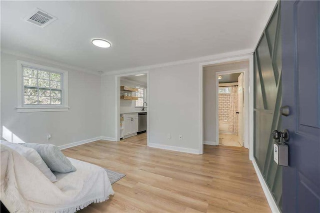 sitting room featuring a healthy amount of sunlight, baseboards, and visible vents