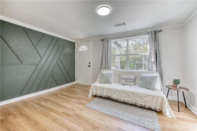 sitting room with baseboards, wood finished floors, and visible vents