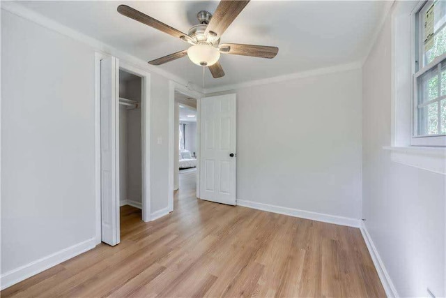 unfurnished bedroom with baseboards, ceiling fan, light wood-style flooring, and a closet