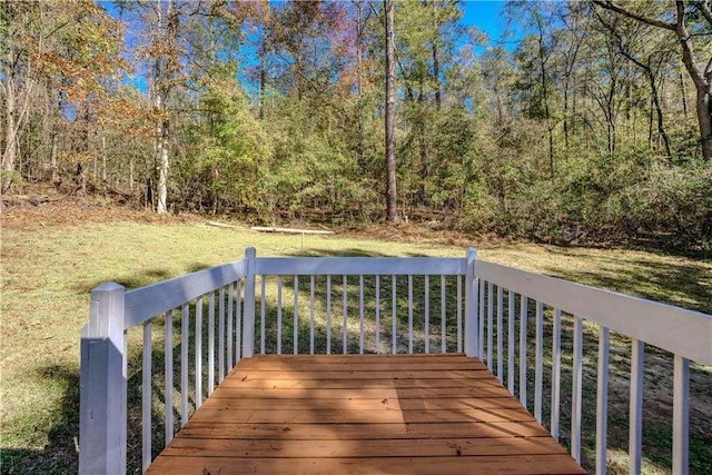 wooden terrace featuring a yard