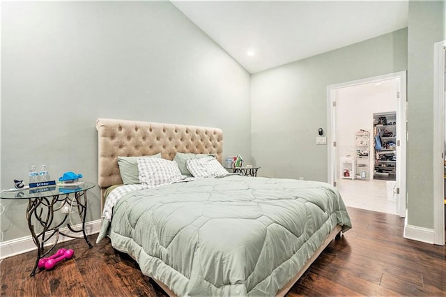 bedroom with recessed lighting, baseboards, vaulted ceiling, and wood finished floors