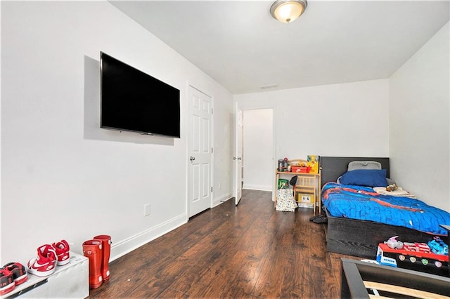 bedroom featuring baseboards and wood finished floors