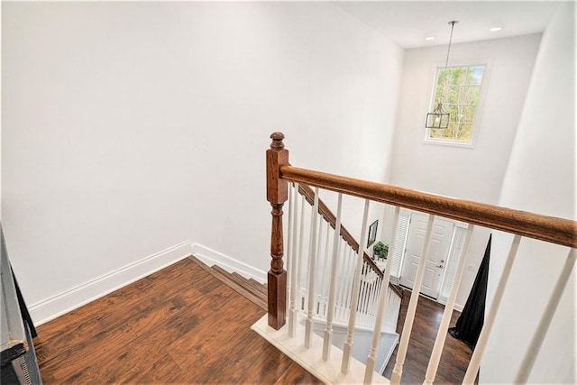 staircase featuring baseboards, recessed lighting, and wood finished floors
