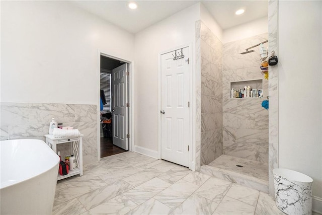 full bathroom featuring recessed lighting, marble finish floor, a freestanding tub, and a tile shower