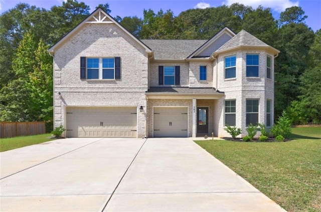 craftsman house with a garage and a front lawn