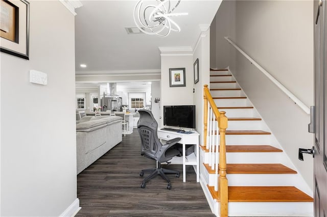 staircase with crown molding, a notable chandelier, visible vents, wood finished floors, and baseboards