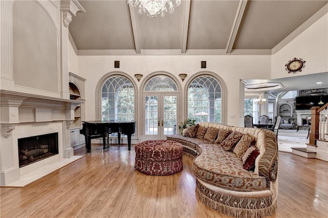 8455 Abingdon Ln, Duluth, GA 30097 - living area with a fireplace, a chandelier, high vaulted ceiling, light wood-style floors, and beam ceiling