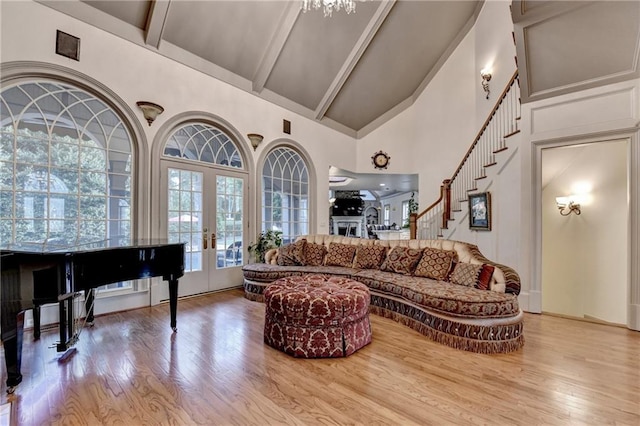 8455 Abingdon Ln, Duluth, GA 30097 - living room featuring high vaulted ceiling, wood finished floors, beamed ceiling, french doors, and stairs